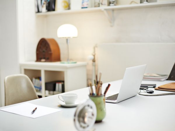 a clean and organized home office desk with a laptop on it