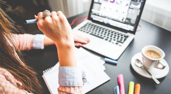 a freelancer working from home while using her laptop